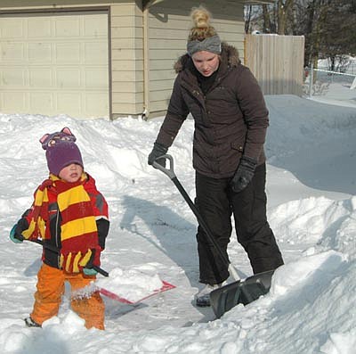 A&#8200;winter storm dumped about 7.3 inches of snow on Stewartville and the area, closing local schools on Monday, Jan. 28. At left, Brenda Smith and her son Roran, 5, of Stewartville, work together to shovel snow from their driveway that morning.