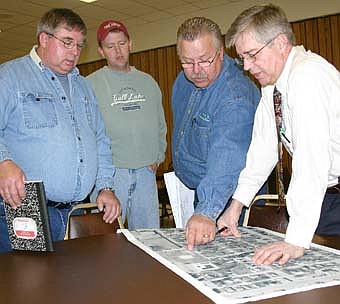 REVIEWING THE PLANS -- Local residents, city officials and representatives of area firms reviewed plans for the Third Street Southwest project at a meeting at the Stewartville  Civic Center last week. From left are Phil Waugh, Matt Boe of Boe Electric, Steve Paulson of Elcor Construction and  Don Borcherding of Yaggy Colby Associates. 