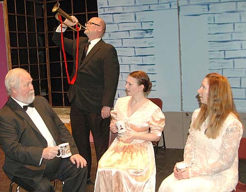 ARSENIC AND OLD LACE -- Teddy Roosevelt (Eldon Anderson), standing, blows his bugle while Witherspoon, (Bob Carlson, left), Abby (Lee Menz), center, and Martha, (Jennifer Reed), left, try to drink their tea during a dress rehearsal for the Stewartville Community Theatre production of Arsenic and Old Lace, which will be presented at the Stewartville High School Performing Arts Center this Friday, March 1 and Saturday, March 2 at 7:30 p.m. each evening and this Sunday, March 3 at 2 p.m. Aaron Rocklyn, the play's director, called the play a humorous farce.