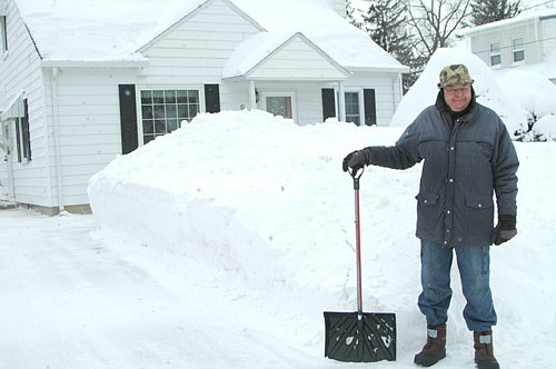 A strong winter storm driven by 45- to 50-miles per hour winds dumped about 12 inches of snow on Stewartville and the area on Saturday, Feb. 16 and Sunday, Feb. 17, adding height to the already-tall snowbanks along the city's streets. Roger Buck, above, who lives at the 600 block of Second Street Southwest, said the snow in his driveway was at least knee deep, with drifts four to five feet high, after the snow stopped falling that Sunday morning. Buck was dreading the thought of using his small snowblower and shoveling his driveway when he saw Bob Wisch, a professional snow remover, working at the house next door. Wisch agreed to remove Buck's snow, a job that took about 45 minutes. "It would have taken me two days to get through it," Buck said. Buck, who has lived in Stewartville for 51 years, said he couldn't remember the snow being any deeper than it was in Stewartville last week. The Feb. 16-17 snowstorm was a sight to behold, he said. "Every time I looked out the window, I saw the snow," he said. "The northwest wind comes right up my driveway, and it just kept coming and coming."