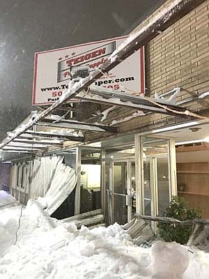 The awning at the front of the Teigen Supply building in downtown Stewartville collapsed under the weight of an extraordinary amount of snow on Saturday, Feb. 23 at about 8 p.m. A winter storm driven by 45- to 50-miles per hour winds dumped about 12 inches of snow on Stewartville and the area on Saturday evening into Sunday morning, Feb. 24, adding more weight to the significant amount of snow that had previously fallen on the awning. Melissa Leuning of Teigen Supply said sheets of tin from the awning let loose and fell, breaking most of the building's front windows. A patron at the nearby DownUnder called Leuning moments after the awning collapsed. "We were able to get everything sealed up that night," Leuning said. "Then we did more cleanup on Sunday so we were able to be back in business come Monday (Feb. 25). It was a heck of a mess and took a lot of man hours to deal with it." Teigen Supply plans to replace the glass from the broken windows after the weather takes a turn for the better. "At this time we plan on keeping the design of the large windows and an awning of some sort," Leuning said. Despite the damage, Leuning said Teigen Supply fared better in the storm than a number of other area businesses and farms. "I can't imagine the impact of having entire roofs collapse on buildings," she said.