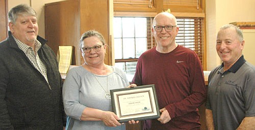 Phyllis and Morrie Schutz, owners of Strikers Corner since 1999, center, accept the Economic Development Authority's Business Appreciation Award at the EDA's monthly meeting at Stewartville City Hall on Tuesday evening, March 19. Jim Kuisle, president of the EDA, left, and Mayor Jimmie-John King, a member of the EDA, presented the award. "Strikers Corner has been a big part of this town," King said.