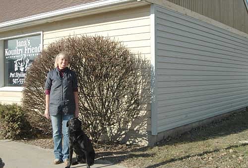 Jana Groski, owner of Kountry Friends, a Stewartville pet care business, poses with her black Lab, Marley, near the store at 301 North Main St. The city of Stewartville's EDA, at a recent meeting, unanimously agreed to pay $4,810, or half the total project cost of $9,620, for new siding for the Kountry Friends building. Randy and Sue Lindquist, owners of the building, applied for the grant from the EDA.