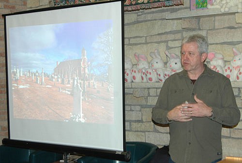 Doug Ohman, a freelance photographer and public speaker, displayed his photos of cemeteries and graveyards on a large screen as he spoke to an attentive audience, left, at the Stewartville Public Library on Thursday evening, March 28.