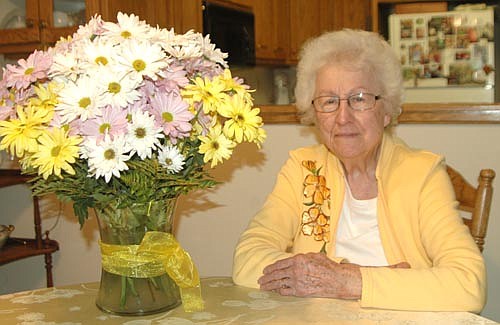 Beulah Ankeny, who turned 100 years old on Saturday, April 20, poses near a bouquet of 100 daisies she received from a friend of her daughter, Sharon Byrne. "I have been blessed with good health," she said. "I have some arthritis and some aches and pains, but I don't let it get me down." She still cooks for herself, and still drives her own car. "I drive out to the grocery store, but that's as far as I go," she said.