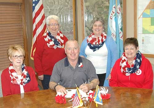  Mayor Jimmie-John King, seated in center, signed a proclamation last week declaring May 24 and May 25 Poppy Days in the city of Stewartville. On those days, members of the Stewartville American Legion Auxiliary, including, clockwise from left, Wanda Prescher, Audrey Farnsworth, Myrna Welter and Peggy Paulson, will collect donations for veterans and veterans programs at Fareway, the downtown Kwik Trip and Casey's North.