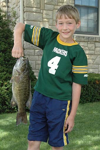 Benjamin Grabau, a 10-year old from Stewartville, caught a three-pound, 18.5-inch long small-mouth bass using a night crawler as bait while fishing in the Root River at Florence Park on July 12.  