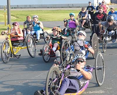 Participants at the National Wheelchair Sports Camp at Ironwood Springs Christian Ranch get off to a good start in the annual Wheels and Heels of Fire 10K event on Sunday morning, June 9.
