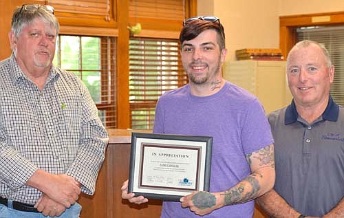 Michael Selkow, store manager for Family Dollar of Stewartville, center, accepts the EDA's Business Appreciation Award from Jim Kuisle, EDA president, left, and Mayor Jimmie-John King, a member of the EDA.
