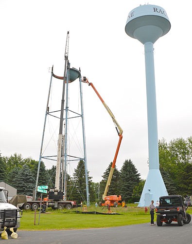 Last week, workers disassembled and took down Racine's old water tower, left, which has served the city since 1962. Last October, a crew from Maguire Iron, Inc. of Sioux Falls, S.D. built a new 140-foot tall water tower, right.