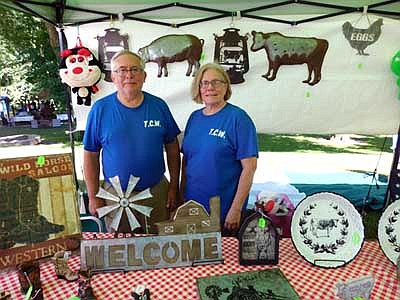 Albin Jr. and Deb Timm of Zumbrota enjoy bringing Timm Custom Woodworking, a business owned by their son, Cory, to Stewartville's Fourth of July Summerfest celebration. "We like the variety of the people, meeting new faces, the comments they make about what we're selling and the suggestions or questioins they have,"&#8200;Deb said.