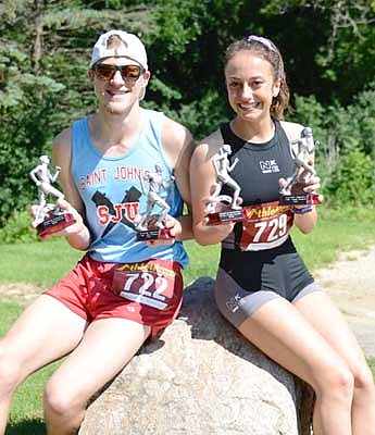 James Mathison of Stewartville and Kendall Pfrimmer of Rochester pose with their trophies after they they each placed first in both the three and five-mile races of the Stewartville Summerfest Run.