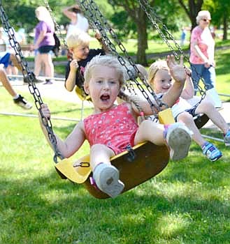 Juliette Dzubay waves and hollers "Hi!" to Mom and Dad as she enjoys the swing ride during the Stewartville Area Chamber of Commerce's annual Independence Day Summerfest celebration on a warm and muggy Thursday, July 4.