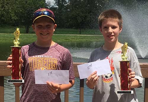 The Stewartville Area Chamber of Commerce held its annual fishing contest at Florence Park during the Summerfest festivities on the Fourth of July. Winners in age group 12-15, from left, are Bradden Erickson, first place, catching a 6 1/2-inch bullhead, and Kenny Skare, second place, with his 4 1/4-inch sunny. The event is sponsored by the Billings family. The deck at the Florence Park Pond was built in memory of Vern Billings to honor his dedication to Stewartville's parks.