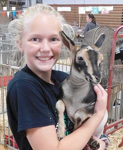 Mackenzie Rogers-Webb, 12, who will be a seventh grader at Stewartville Middle School, with Mable, a young goat.