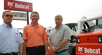 GLAD TO BE HERE -- From left, Craig Stier, owner-manager of Bobcat and Valley Trailer Sales; Randy Mitchell, general manager of Featherlite Coaches; and Jeff Thorsen, owner-manager of Bobcat and Valley Trailer Sales, are happy to be in Stewartville. 