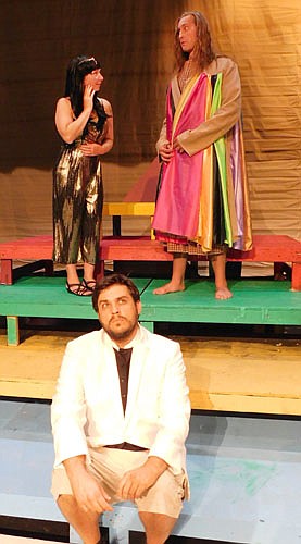 Potiphar (Ryan Frank), seated, wonders if his wife (Jennifer Reed), left, is getting along with Joseph (Dave Stepan), right, in a dress rehearsal for the Stewartville Community Education Theatre production of Joseph and the Amazing Technicolor Dreamcoat.