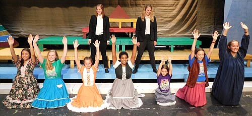 The narrators, Katie Eberhard, standing left, and Angela Fitzpatrick, standing right, look on as the Young People's Chorus, including, from left, Petra Algadi, Olivia Nicklay, Matilda Dube, Kiya Smith, Sloan Bolster, Flora Bolster, and Rachel Eberhard, sing with glee during a dress rehearsal for the Stewartville Community Theatre presentation of Joseph and the Amazing Technicolor Dreamcoat. The show will continue with performances at the Stewartville High School Performing Arts Center this Friday, Aug. 9 and Saturday, Aug. 10 at 7:30 p.m. each evening, and this Sunday, Aug. 11 at 2 p.m.  For tickets to the show, call (507) 533-1650.