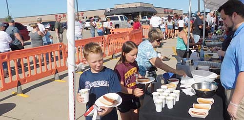 Five northeast Stewartville businesses served more than 1,100 free hot dogs to hundreds upon hundreds of guests at the seventh annual Dogs Days of Summer celebration near Fareway on Thursday, Aug. 8.  "It was our best turnout ever," said Robert Hruska, grocery manager of Fareway. "The weather was perfect, and we had a good-sized line from 4:30 until about 6 o'clock."