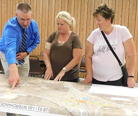 John Bernhardt of Stewartville, left, points to a specific intersection on a map showing the Minnesota Department of Transportation's plans to improve the Hwy. 63 and Interstate 90 interchange just north of Stewartville. Joining Bernhardt are, from left, Jan Janssen of Stewartville and Jeanne Fischer of rural Stewartville. The three were among many Stewartville and area residents who attended a MnDOT-hosted open house at the Stewartville Civic Center on Tuesday, Aug. 13 from 4 p.m. to 6:30 p.m.