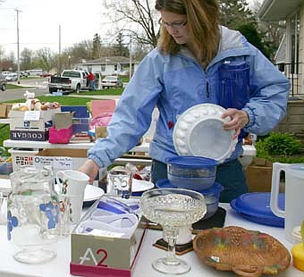 A GOOD SELECTION -- Stephanie Skogen, 28, of Pine Island, looks over the items available at a garage sale near St. Bernard's Catholic Church on Friday, May 9. Hundreds of visitors took part in the annual citywide garage sale that day. 