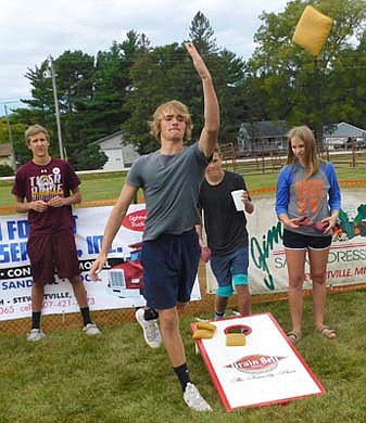 Zack Schreiber, a freshman at Stewartville High School, shows good form as he tosses a beanbag during the High Forest Old Settlers Day Beanbag Tournament on Saturday, Sept. 7. He said he enjoys Old Settlers Day for the music, the food and the fun.