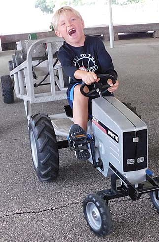 Maxwell Stensrud, 5, of Minnetonka, gives his all as he competes in the kids pedal tractor pull at High Forest Old Settlers Day on Saturday, Sept. 7. Maxwell placed second in the 5-year-old age group.