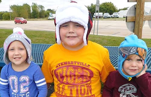 From left, Bryleigh Hodapp, 3, and siblings Payton, 7, and Jackson, 1, wear the hats their grandmother, Deb Hodapp, bought from the Sisters' Shop at the Stewartville Morning Lions Club's annual Fall Festival. Deb purchases the hats from the Sisters' Shop every year.