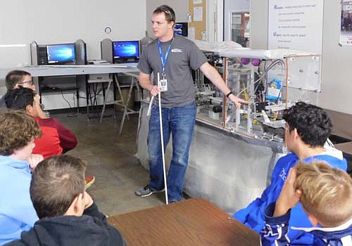 Cody DuPont, GEOTEK's product manager, explains to a group of Kasson-Mantorville students how the company makes its PUPI brand of fiberglass cross arms for utility poles.