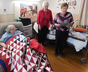 Linda Frost, an Army veteran and resident of the Stewartville Care Center, left, accepted a Quilt of Honor at the Stewartville Care Center on Wednesday, Oct. 9. Marie Wilson, far right, presented the colorful quilt to thank Frost for her service to America. Sondra Bentz, a friend of Frost's, is in the center.