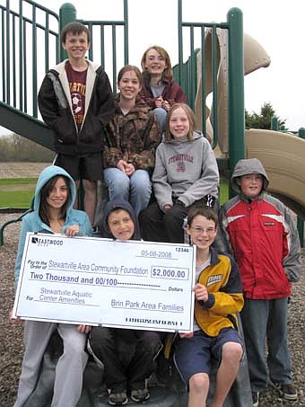 FAMILY GENEROSITY -- Eight families from the Brin Park area  have donated $2,000 to help pay for two slides for Stewartville's new pool, expected to be completed by mid-June. Family members include, front row, from left, Mackenzie King, Brandon Lange, Robert Corsini and Nathan Lange. Back row, from left, Conner Corsini, Jenna O'Byrne, Chelsea Lange and Kara O'Byrne.  These families hope other neighborhoods and individuals will follow their lead and come forward with donations for the new pool. 