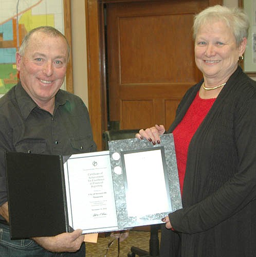 For many consecutive years, Barb Neubauer, right, and the city of Stewartville earned the Certificate of Achievement for Excellence in Financial Reporting. In this STAR file photo, Mayor Jimmie-John King, left, presented the award to Neubauer, the city's finance director, in October 2015.