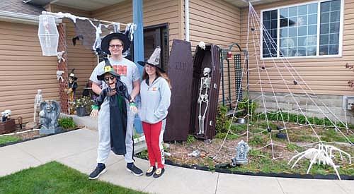Jennifer Reed and her son Cooper pose near the Halloween decorations at their home at 2000 Petersen Drive Northwest. The Reeds enjoy decorating for Halloween every year, Jennifer said. "It's a family thing,"&#8200;she said. "We've done it for about 18 years, and every year, it grows."  Jennifer has a soft spot in her heart for Halloween. "I love seeing everybody happy," she said. "It's a good way to have some fun. It's fun for the kids." Rick Reed, the father of the family, also enjoys the fall holiday. "It's a blast," he said. "The weather is nicer than it is decorating for Christmas, so you can really enjoy it."