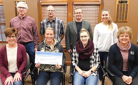 Tyne Wynn, art teacher at Bear Cave Intermediate School, seated second from left, accepts a $3,000 check from the Stewartville Area Community Foundation. The funds will help the school pay for a new kiln for students in grades three through five. SACF Board members include, front row, from left, Lisa Lonien, Regan Lonien and Ann Lutteke. Back row, from left, Jeff Beyer, chairperson of the Foundation, Al Chihak, Dan Honsey and Emily Fritsch.