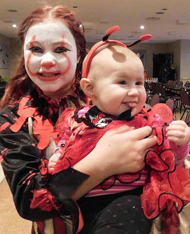 Children and their parents visited the Stewartville American Legion Post 164 in large numbers to enjoy a Halloween party on Thursday, Oct. 31. Here, Chloe Carlino, a fifth grader at BCI, dressed as Pennywise from the movie It, holds younger sister Harper Carlino, 6 months, dressed as a ladybug. 