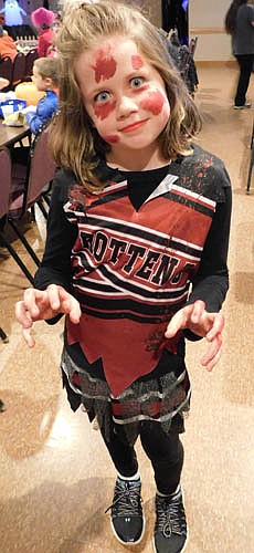 Children and their parents visited the Stewartville American Legion Post 164 in large numbers to enjoy a Halloween party on Thursday, Oct. 31. Here, Nora Fordahl, 9, a fourth grader at Bear Cave Intermediate School (BCI), poses as a zombie cheerleader for Rotten University.