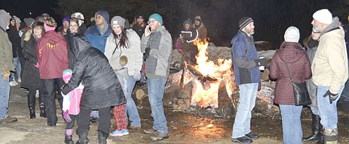 Hundreds of local and area residents attended "Santa's Winterland," part of the Stewartville Area Chamber of Commerce's annual Winterfest celebration, at Florence Park on Saturday evening, Dec. 7. Here, residents gather to warm up near a bonfire.