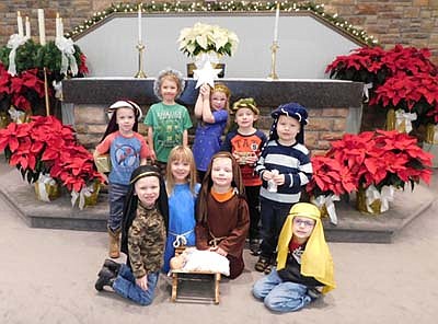 The children at the St. John's Wee Care Learning Center presented their Christmas plays at St. John's Lutheran Church on Sunday, Dec. 14. During the week leading up to that date, some of the children, all decked out as Mary, Joseph, the shepherds and the Magi, practiced their presentation by gathering around the Baby Jesus in the manger.