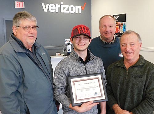 Kyler Deetz, manager of Stewartville's Verizon store, front and center, accepts the Economic Development Authority's Business Appreciation Award from, from left, Jim Kuisle, president of the EDA; Bill Schimmel Jr., city administrator; and Mayor Jimmie-John King, a City Council representative on the EDA.