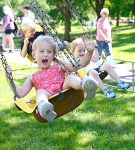 Juliette Dzubay waves to her parents as she enjoys the swing ride at Stewartville's Independence Day Summerfest celebration on Thursday, July 4.