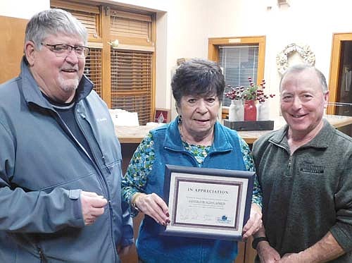 Sharon McAtee, site coordinator for the Center for Active Adults, center, accepts the Stewartville Economic Development Authority's Business Appreciation Award from Jim Kuisle, president of the EDA, left, and Mayor Jimmie-John King, EDA member, right.