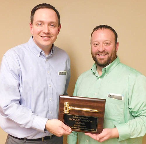 Nick Johnson of Thrivent Financial, incoming president for the Stewartville Area Chamber of Commerce for 2020, accepts the ceremonial gavel from Mike Rainey of Bremer Bank, who served as the Chamber's president in 2019.