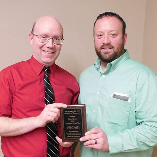 Robert Hruska, grocery manager of Fareway of Stewartville, left, accepts the Stewartville Area Chamber of Commerce's Volunteer of the Year Award for 2019 from Mike Rainey of Bremer Bank, outgoing Chamber president.