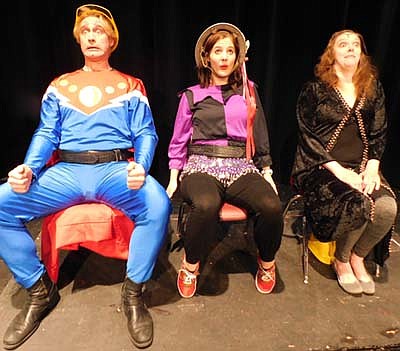 Flash (Dave Stepan), left; Dale (Katie Eberhard) center; and Desira (Ashley Linarducci), right, prepare for blastoff during a dress rehearsal for the Stewartville Community Theatre production of Flash Gordon The Musical.