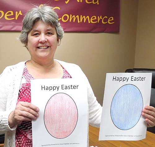 Myrna Welter, membership coordinator for the Stewartville Area Chamber of Commerce, displays samples of Easter Egg drawings that will be placed on the windows of local businesses during the Chamber's Easter Egg Hunt April 10-14.