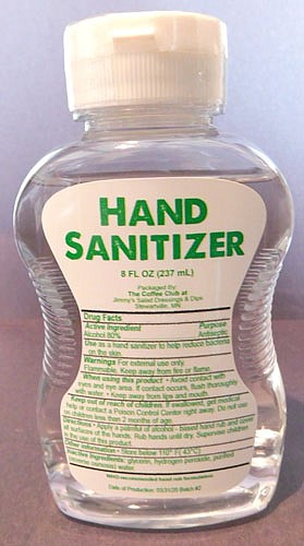 Workers from The Coffee Club at Jimmy's Salad Dressings & Dips bottled hand sanitizer made from alcohol from Harmony Spirits, a craft distillery from Harmony, Minn. Here is bottle of the finished product, many of which will remain in Stewartville.