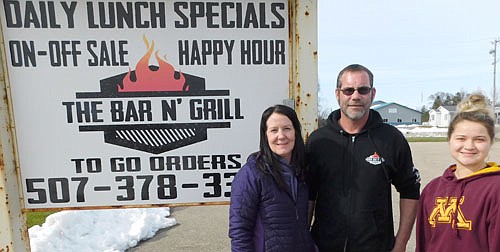 Bobby and Angela Carr, co-owners of Carr's Bar N' Grill of Racine, center and left, and Abby Lee, a waitress, right, are grateful that a number of area businesses and organizations have paid their restaurant-bar to provide free meals to health care workers and others.