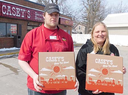 Ben Swain, an employee at Casey's South, left, and Amy Peterson, the store's manager, have been busy taking customers' special orders for pizza. Bill and Char Ferrie, former Stewartville residents, recently ordered Casey's pizzas for the health care workers at Olmsted Medical Center in Stewartville.