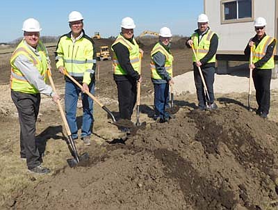 City officials and area builders gathered last week to break ground for Flats 55, a new 55-unit apartment complex to be built near Bear Cave Intermediate School. From left are Bill Schimmel Jr., city administrator; Dan Erdahl, superintendent for Schoeppner Construction of Rochester; Bryan Schoeppner, contractor; Mayor Jimmie-John King; Jeremy Kane, construction manager for Schoeppner; and Darren Groteboer, partner with PGGM1 LLC, the developer for the project.