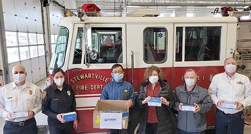 Yang Zhang (Qui) of Pandemic Responders, third from left, donated surgical masks to help Stewartville Area First Response get back in service. State Sen. Carla Nelson (R-Rochester), third from right, Mayor Jimmie-John King, second from right, and City Administrator Bill Schimmel Jr., far right, helped Zhang (Qui) coordinate the donation. At far left, from left, are Vance Swisher, fire chief, and Lisa Jelinek, EMS director.